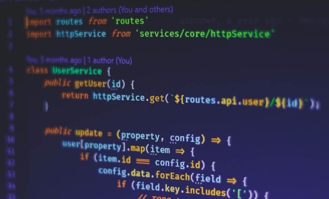 Software code on computer monitor with colorful syntax highlighting in dark editor